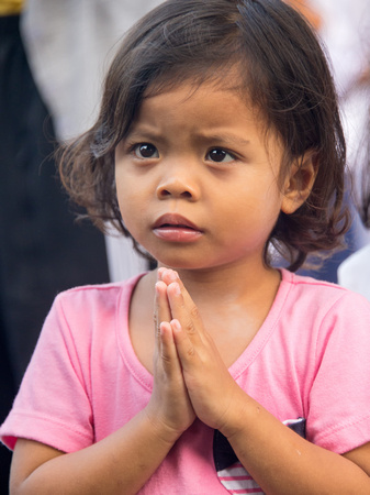 A praying girl in Thailand